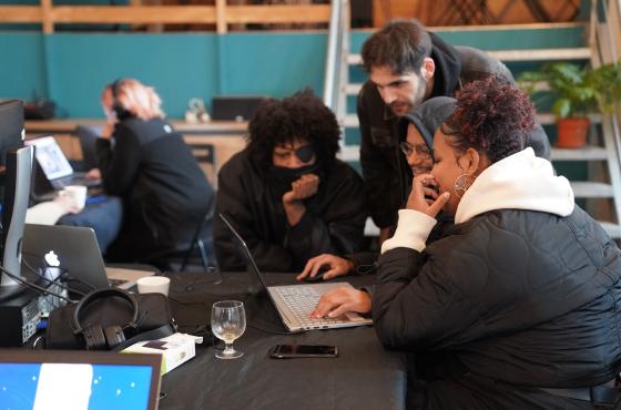 Workshop participants watching a game together on a laptop.